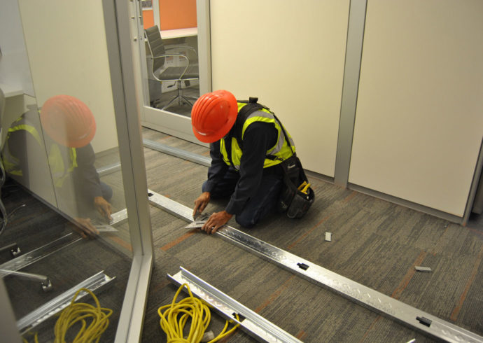 construction worker cutting metal studs